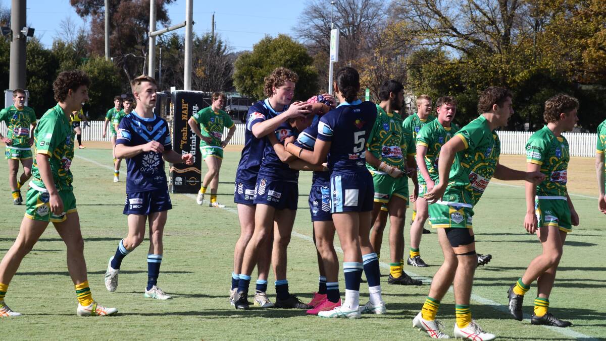 Orange Hawks players celebrate a try during the under 18s derby. Picture by Carla Freedman 